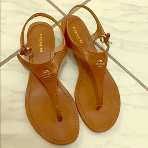 Coach tan leather sandals with one inch heels.